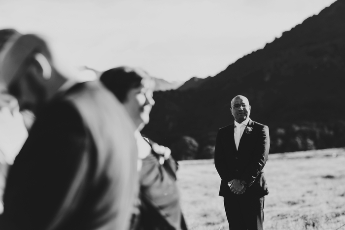 B&W candid image of Groom waiting for bride to arrive at Wedding Ceremony Mt Aspiring National Park, New Zealand
