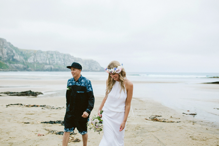 bride and groom walking Caitlins beach
