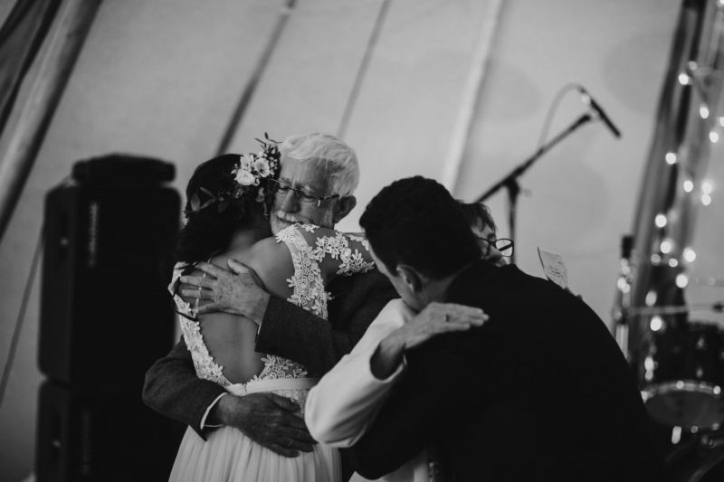 bride and groom hug parents