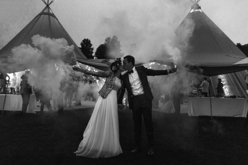 bride and groom with smoke bombs
