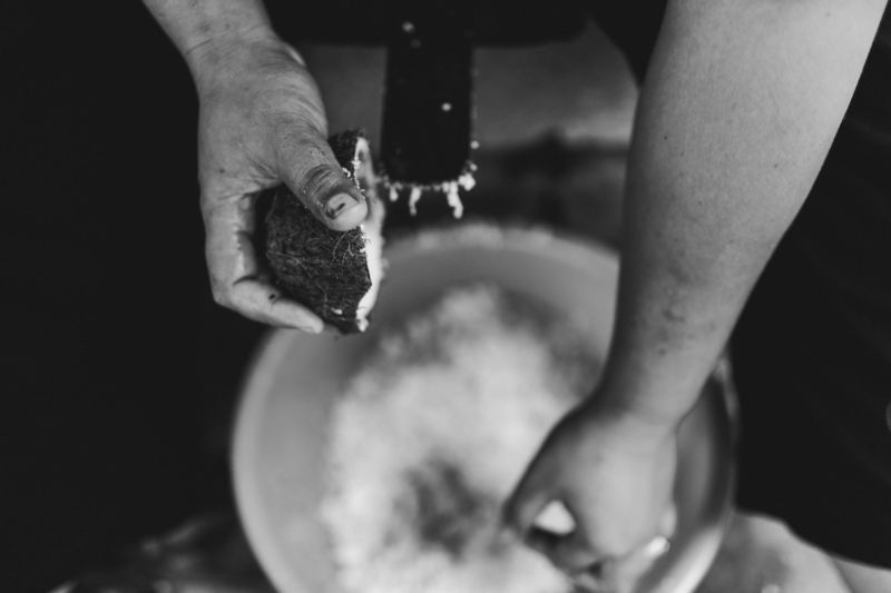 close up of hands making coconut milk
