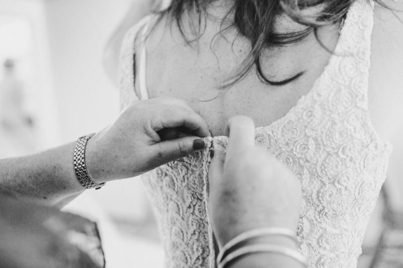 brides dress being done up
