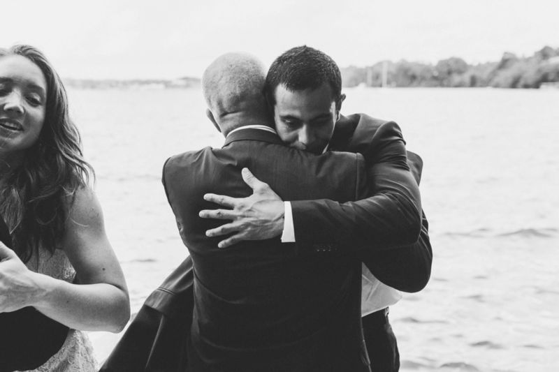 groom hugging father after ceremony