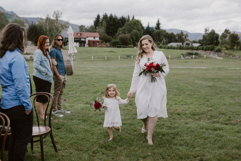 bridesmaid arriving with flowergirl