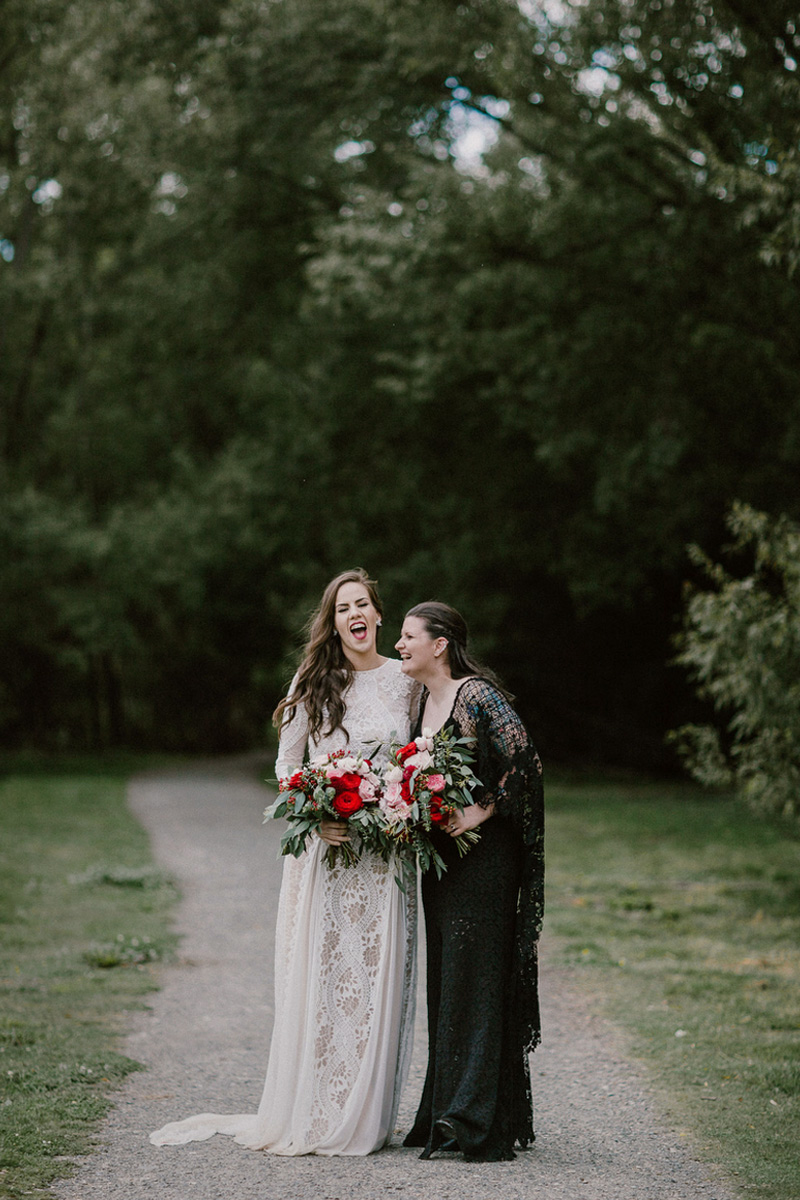 bridal portrait on a path with trees in background laughing