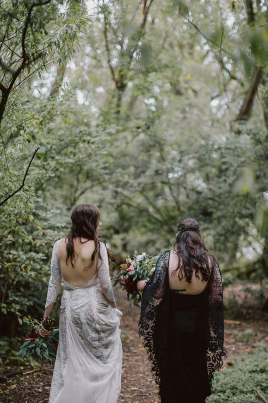 brides walking away in forest
