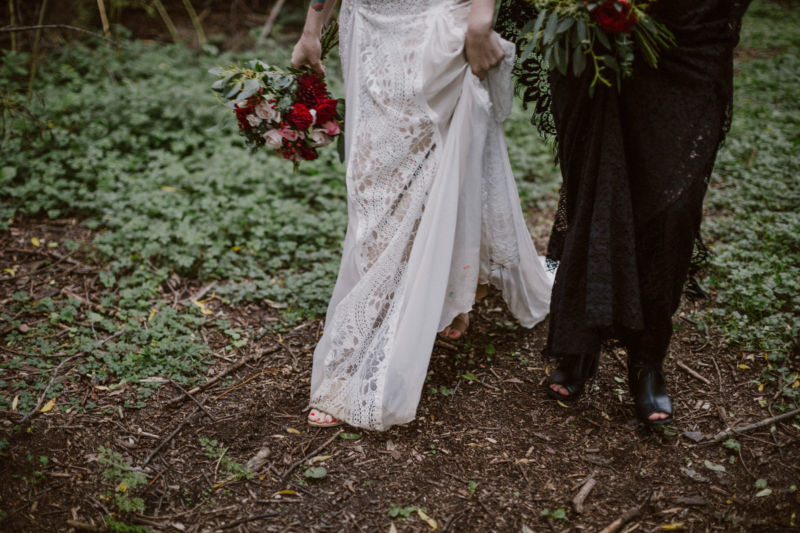 close up of brides dresses in forest