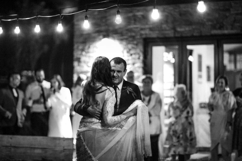 b&w of bride dancing with her dad outside under lights