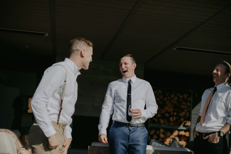 groom laughing out loud with groomsmen