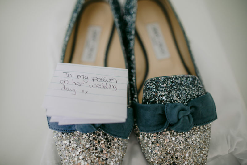 close up of brides sparkly shoes with a sweet note attached