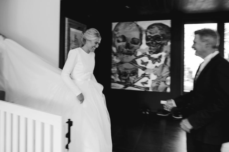 bride descending the stairs to greet her awaiting father