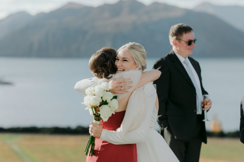 guest hugging bride to congratulate them