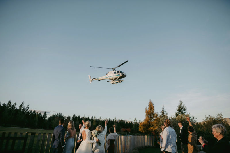 guests waving to helicopter as it leaves