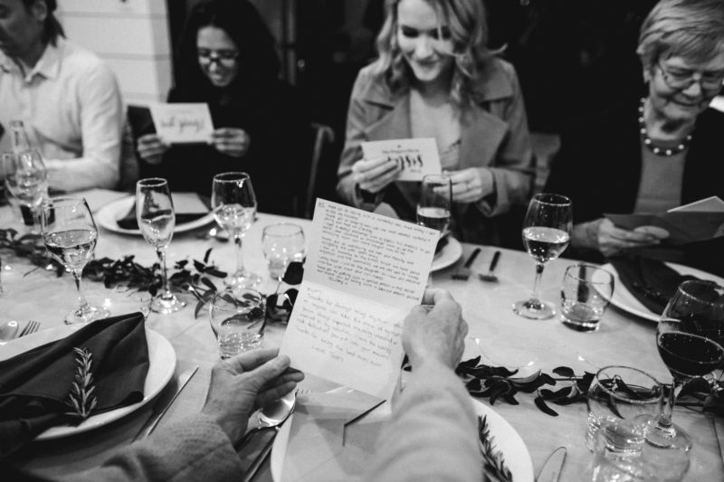 b&w of guests opening personal letters