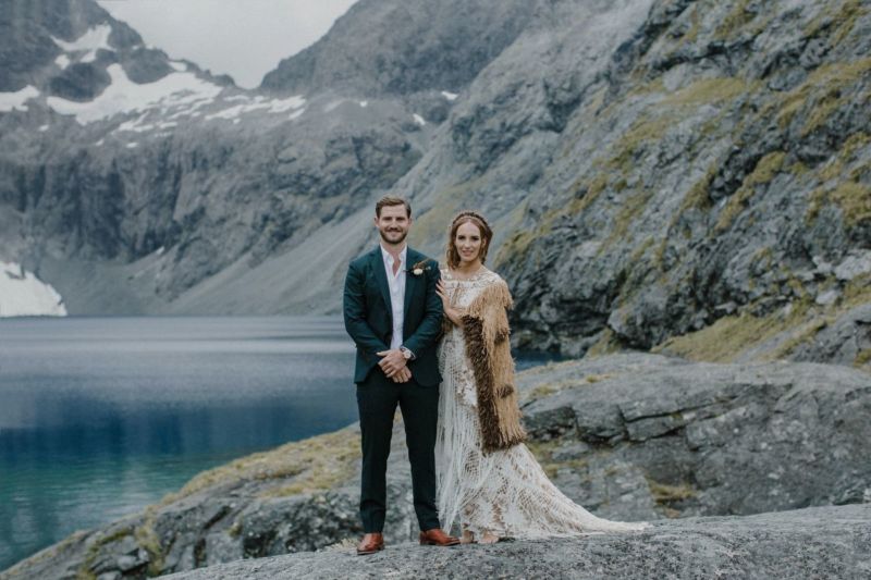 portrait of bride and groom in front of lake