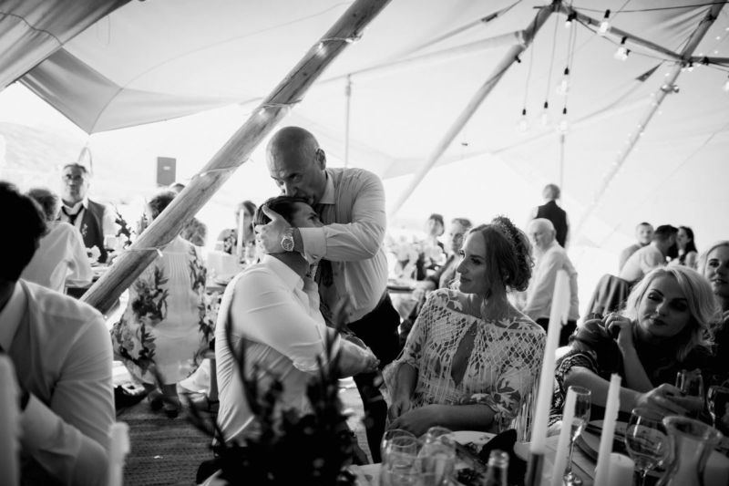 brides dad kissing groom on the head
