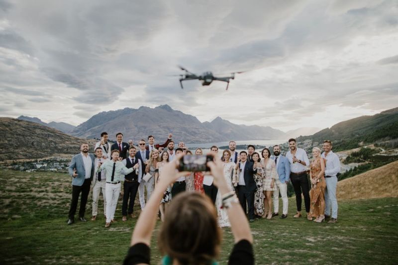 group photo with drone and guest with phone getting in the way