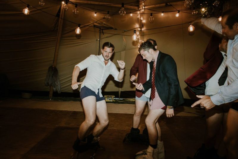 groom and men on dancefloor with pants down