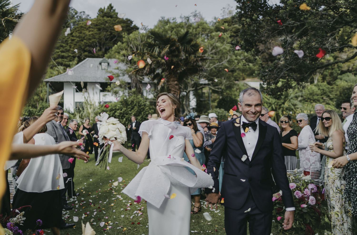 overjoyed bride and groom after ceremony with confetti