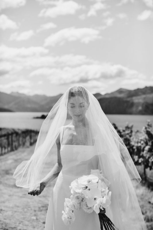 b&w of bride with veil over her face