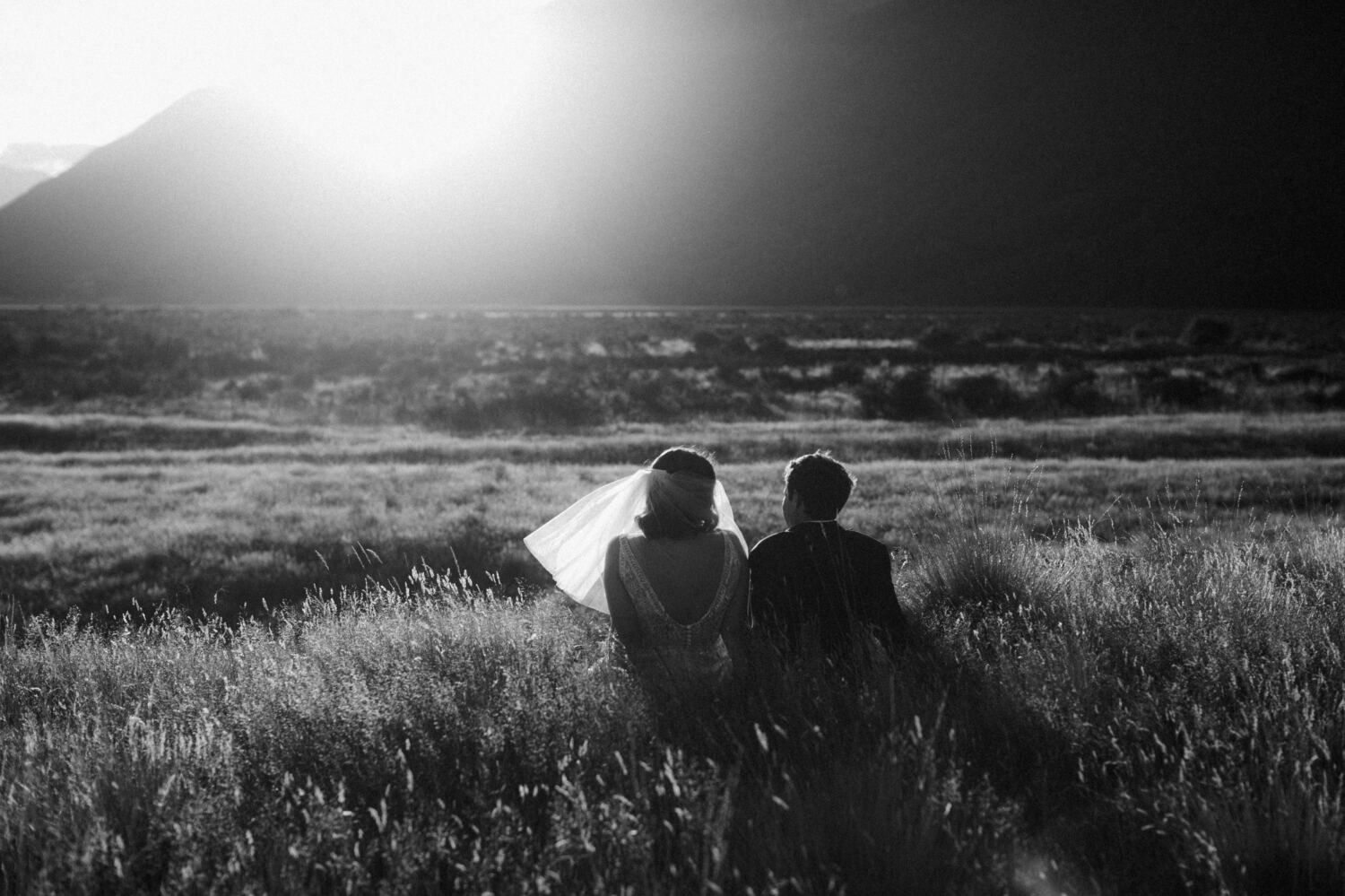 Bride and Groom sitting enjoying sunset