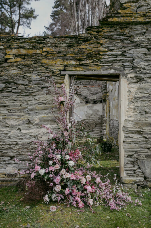 Close up of Thurlby Domain ruins with pink floral arrangement decor for the ceremony
