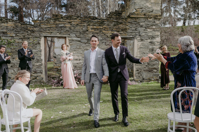 Liam and Steve just married, walking back down the aisle grabbing mums hand on the way