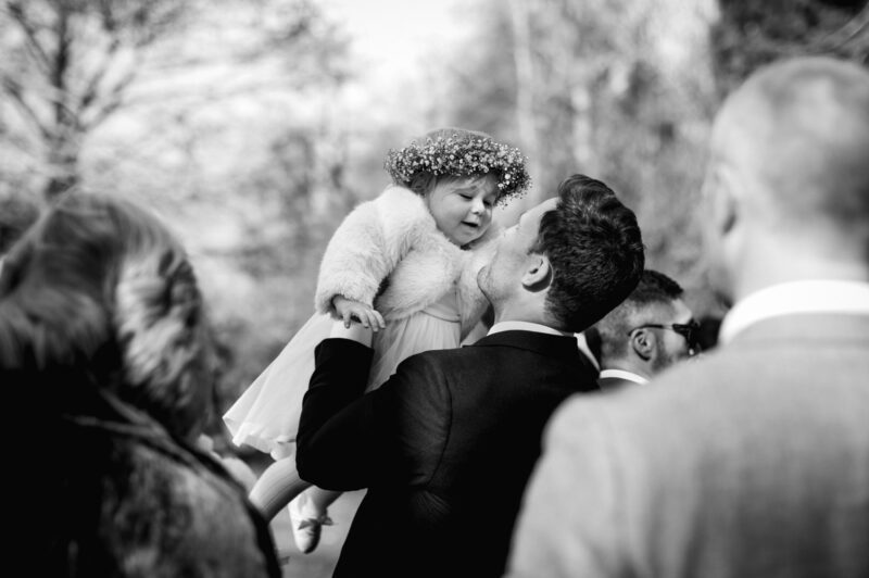 Steve lifting tiny flower girl into the air