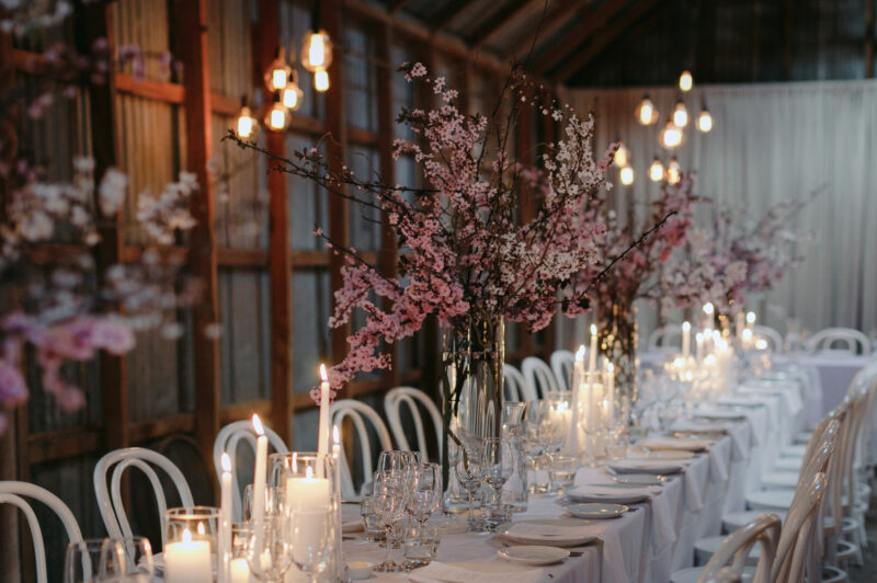 Close up of Liam and Steves Reception venue with tables, candles and flowers tablescape