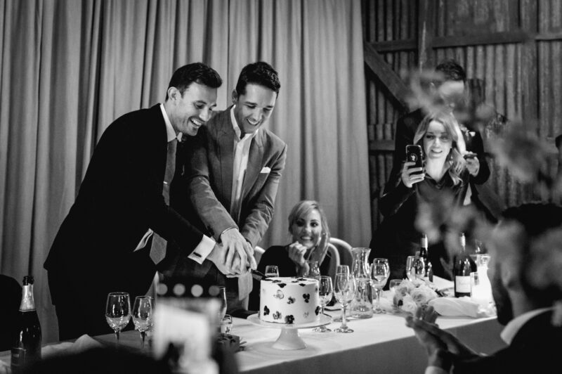 Steve and Liam cut the cake at their table