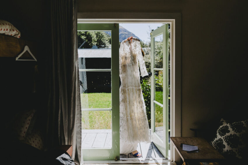 Wedding dress being carried through doorway