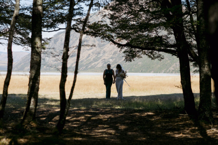 Bride and mother approaching silhouetted