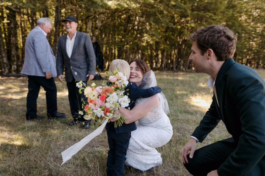 Bride hugging boy