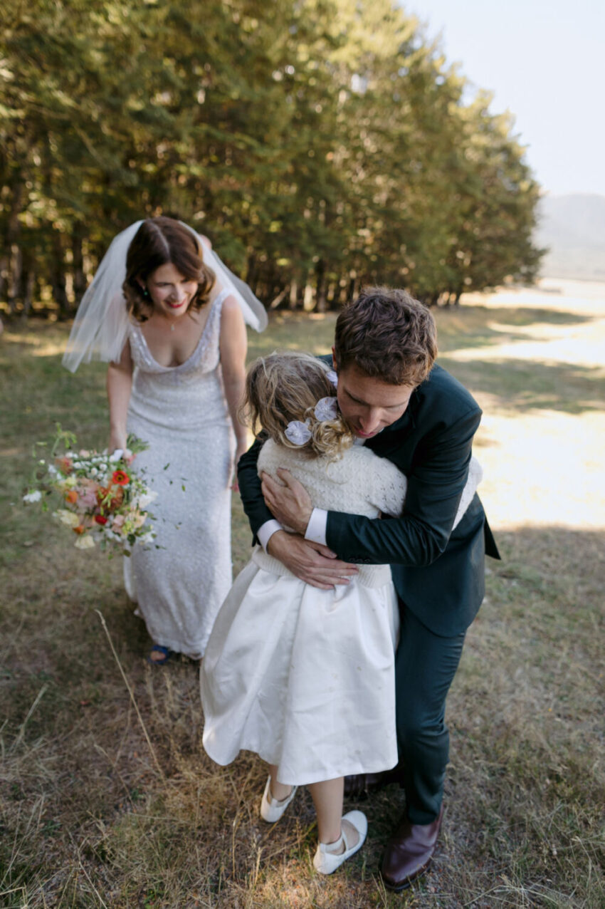 Groom hugging girl