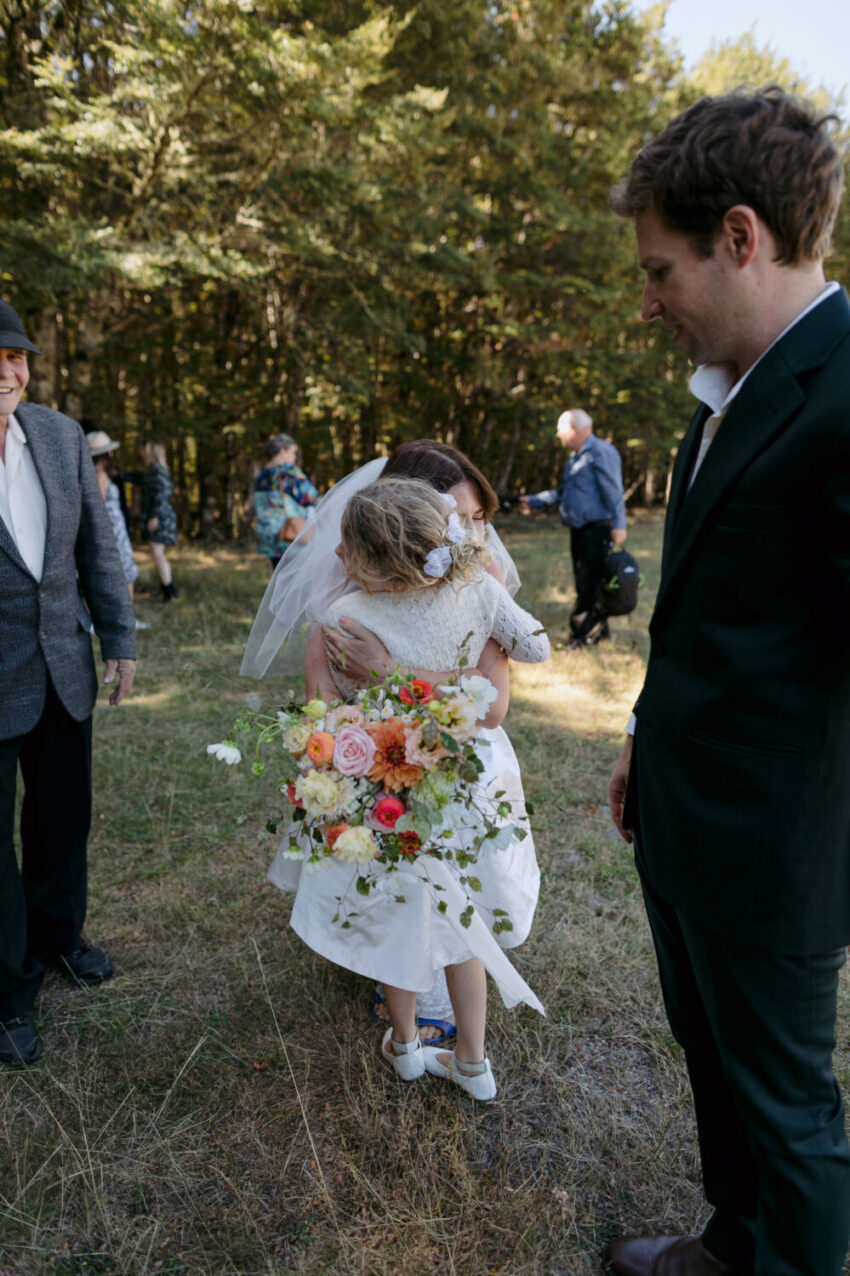 Bride hugging girl