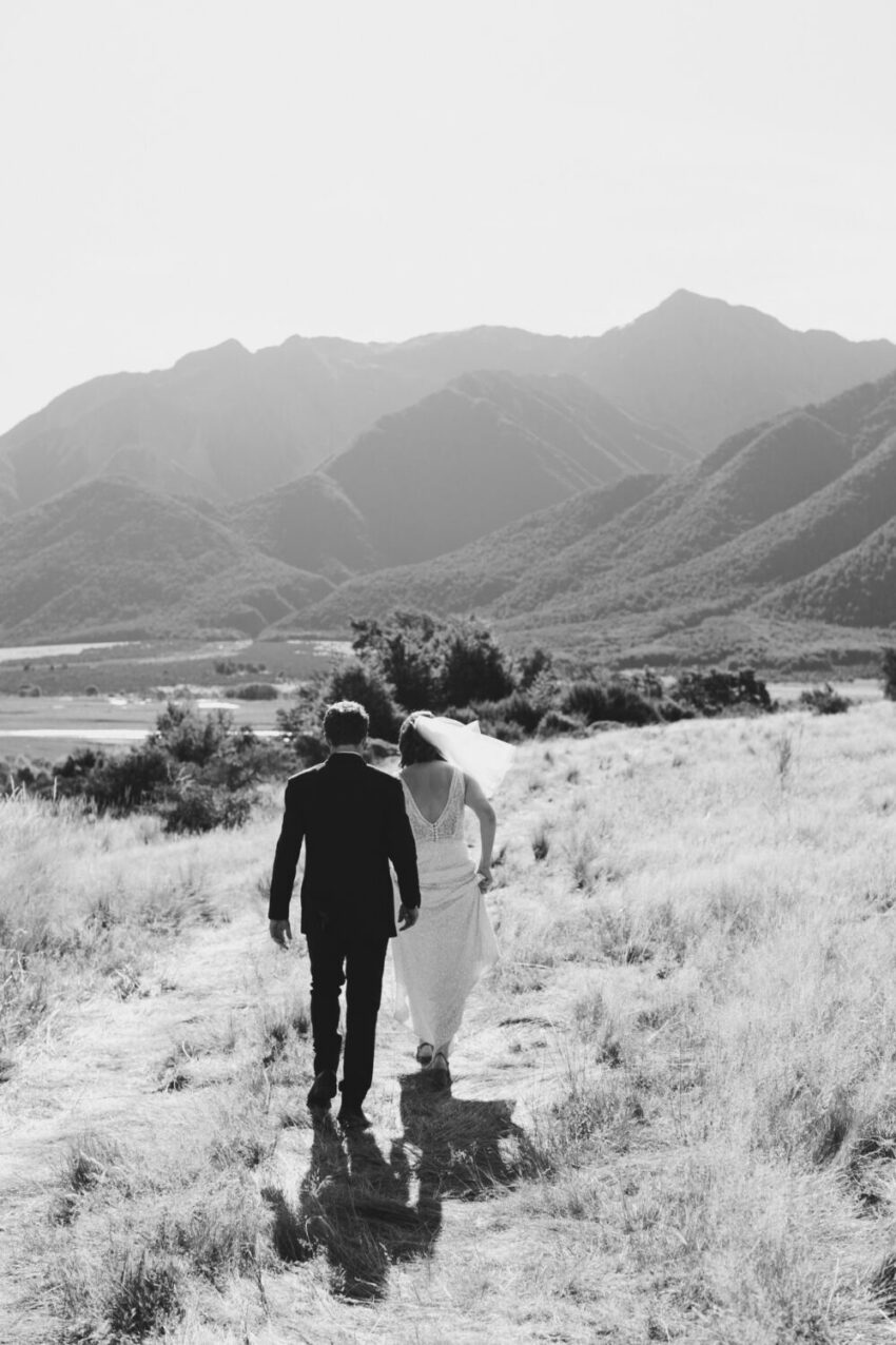 Bride and Groom walking into a scenic landscape