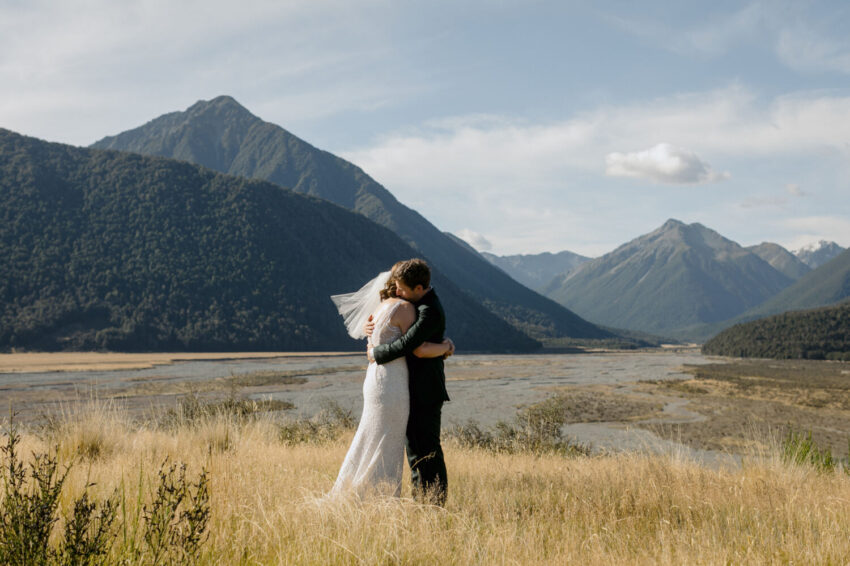 Bride and Groom hugging in a scenic landscape
