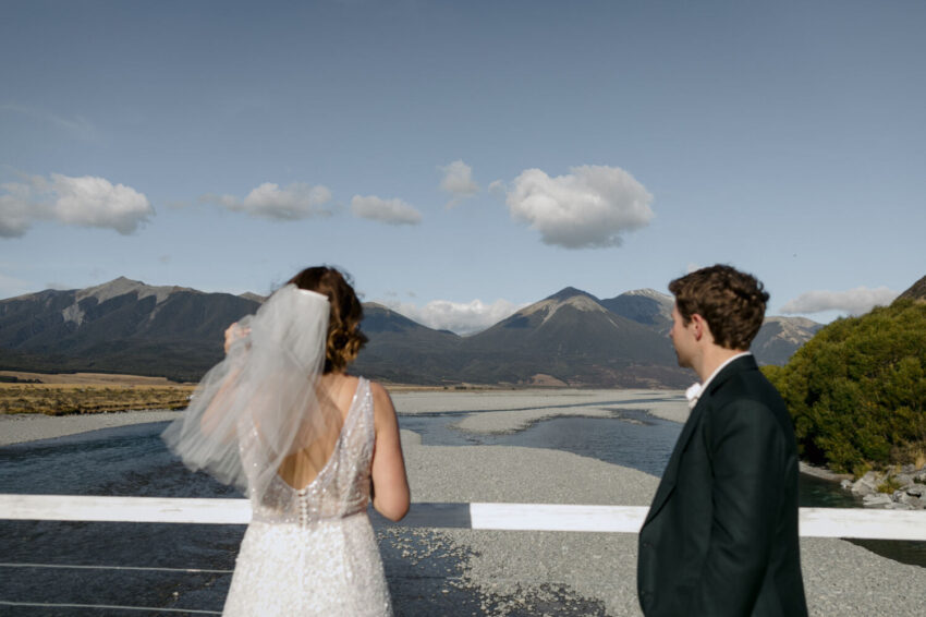 Bride and Groom looking at view from the bridge