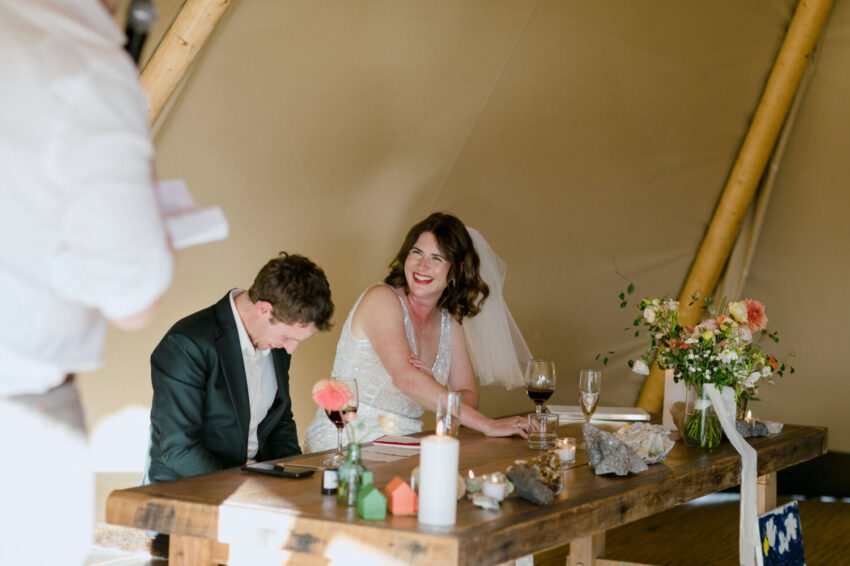 Bride and Groom laughing during speeches