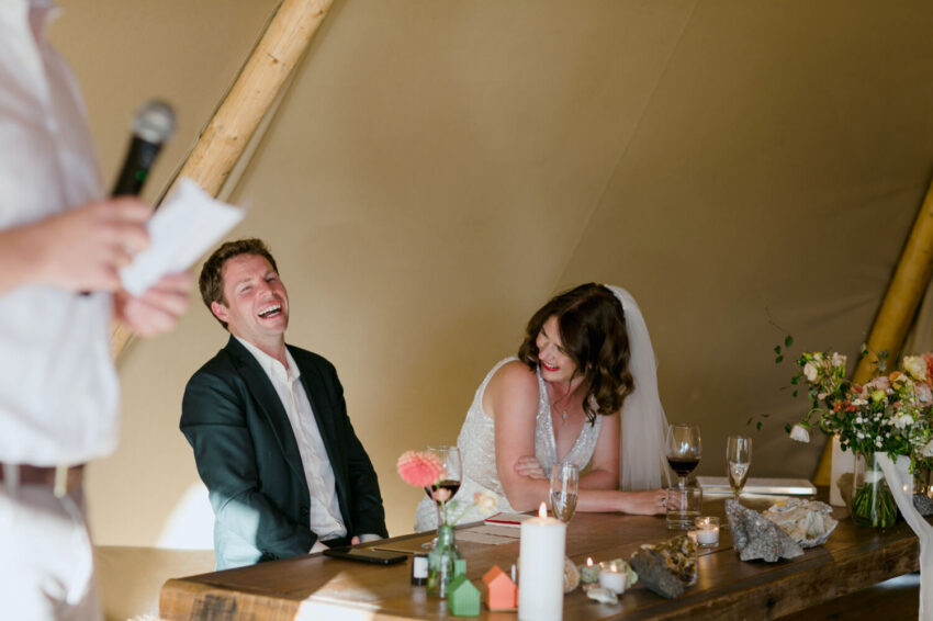 Bride and Groom laughing during speeches