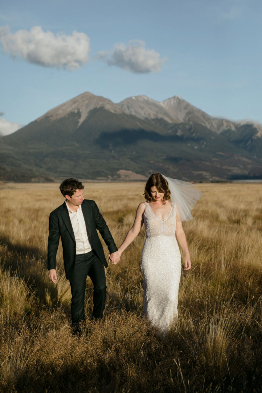 Bride and Groom happily walking holding hands