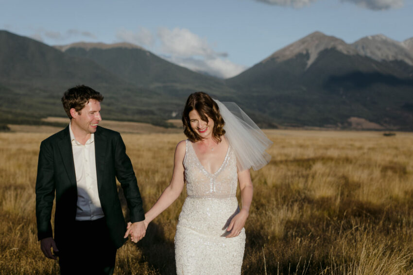 Bride and Groom laughing holding hands