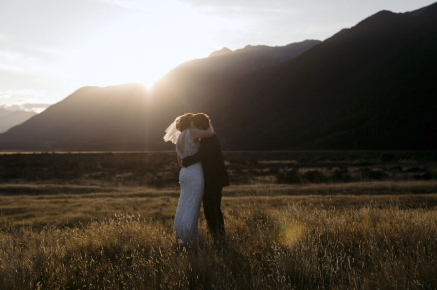 Bride and Groom hugging in sunset