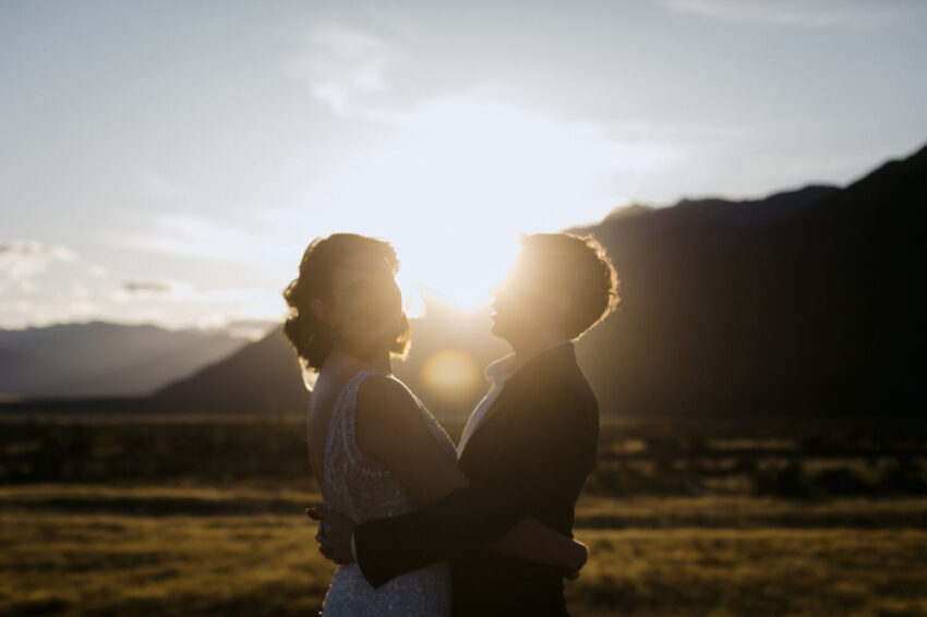 Bride looking back to camera with sun setting behind