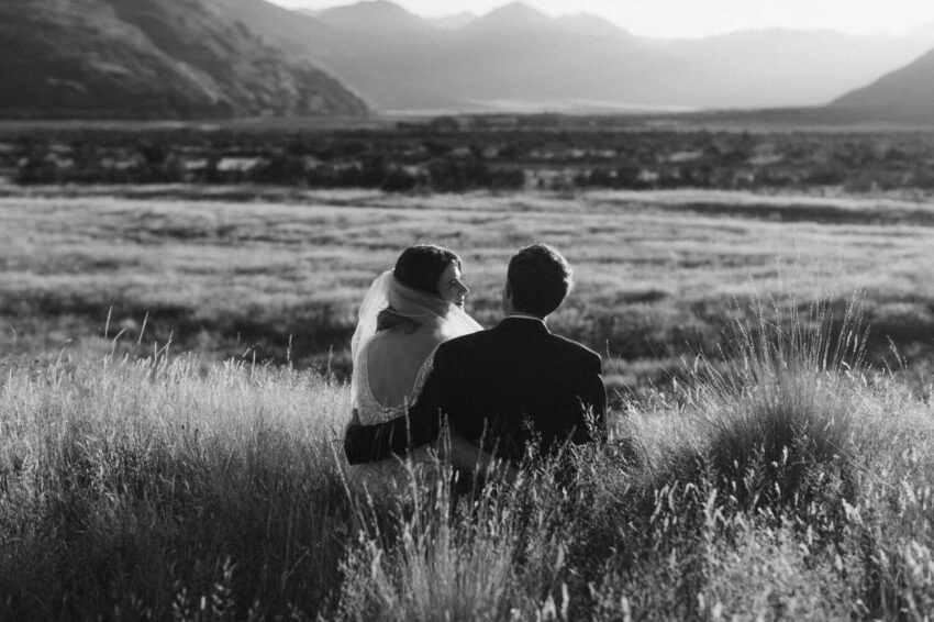 Bride and Groom sitting enjoying sunset