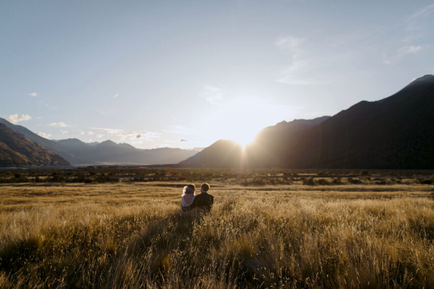 Bride and Groom sitting enjoying sunset