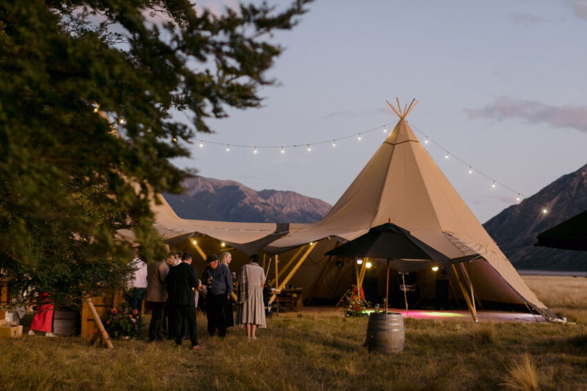 Candid of guests mingling outside tipi