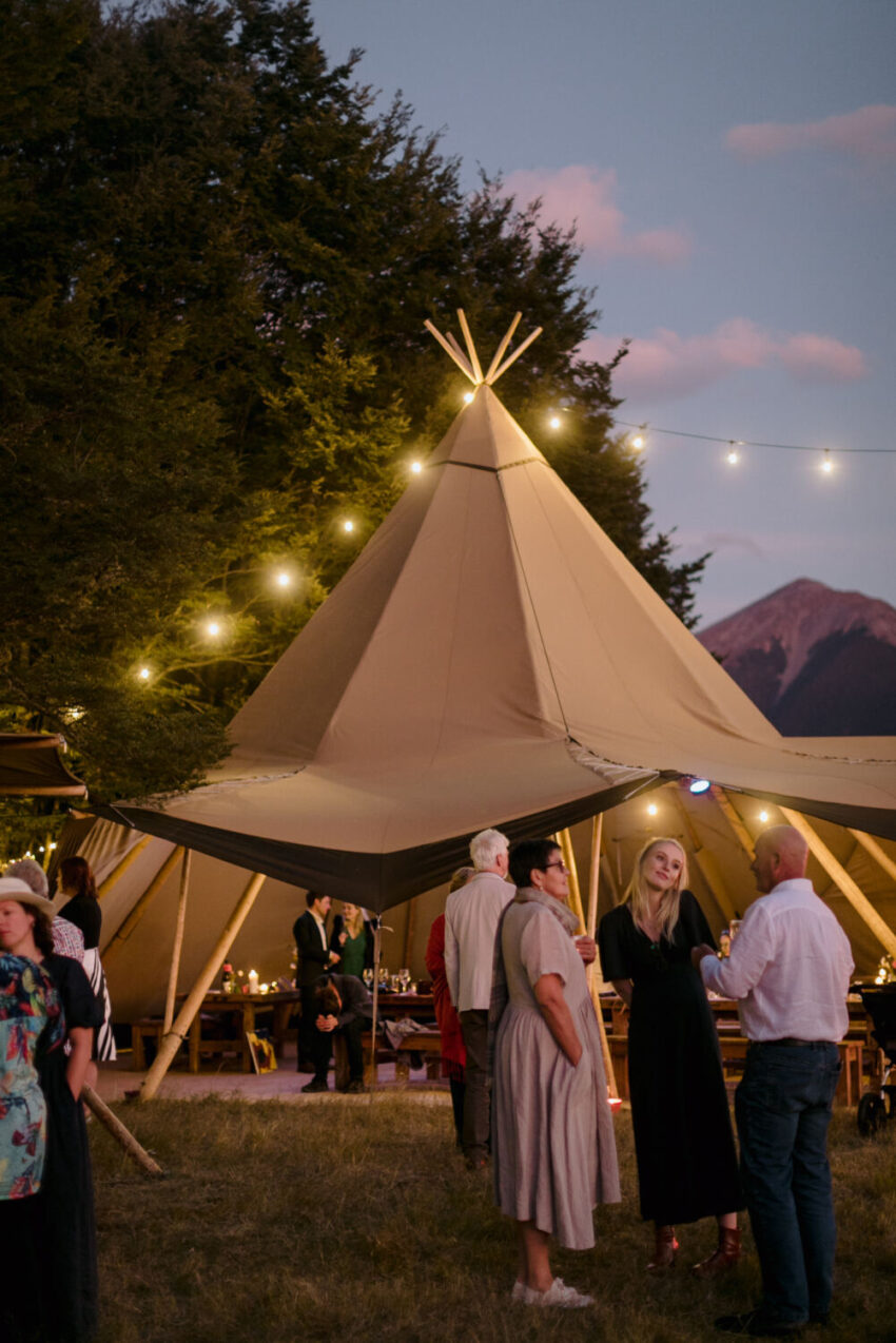 Candid of guests mingling outside tipi