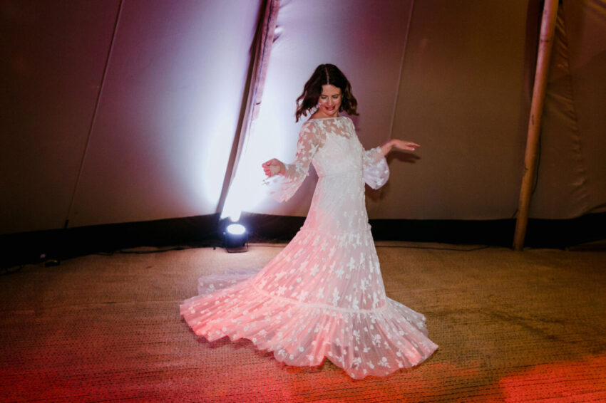 Bride swirling her dress on the dancefloor