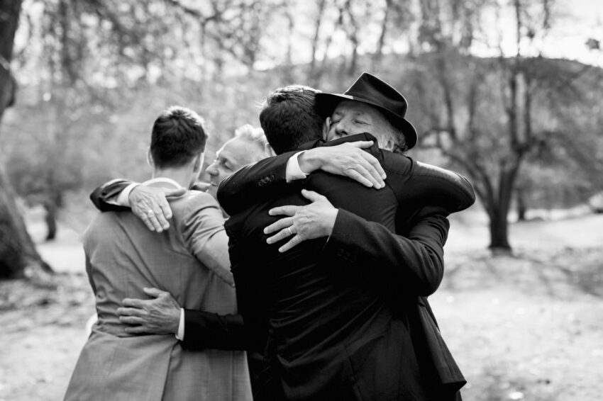 a candid hug of congratulations from Father of the Groom